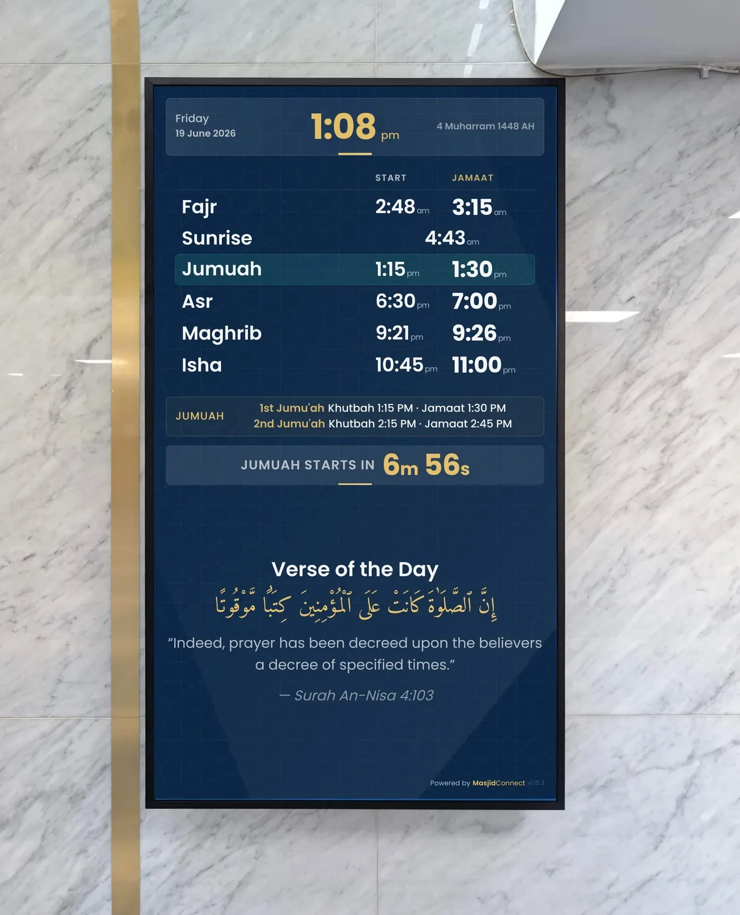 A portrait MasjidConnect screen on the marble wall at Lye Ghausia, showing the day's prayer and jamaat times